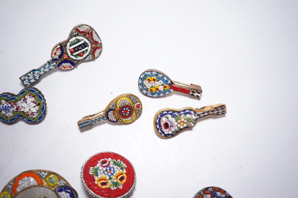 A collection of twenty-eight brooches, including fourteen mixed guitar and banjo shaped brooches, six large oval brooches, seven smaller brooches and one small oval., Condition - good